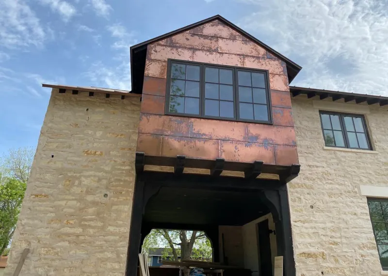 Copper metal panel facade on a stone building for Skylight Installation in Kayenta
